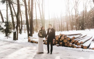 wedding-couple-standing-outside-in-the-snow-holding-hands