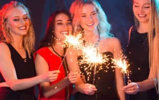 women holding sparklers