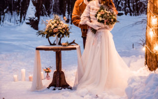 Wedding couple posing in winter snow
