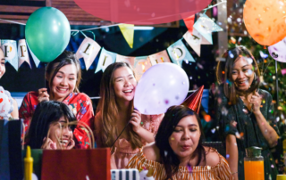 women-at-a-birthday-party-celebrating-with-confetti-as-a-woman-blows-out-candles