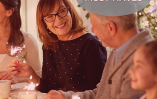 older-woman-smiling-at-dinner-table-at-holiday-party