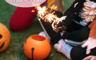 kids-at-halloween-party-in-costumes-holding-sparklers