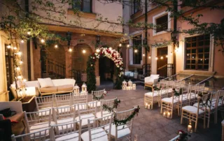 Red peonies and white hydrangeas pinned chairs before wedding