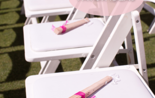wedding-chairs-with-fans-sitting-on-each-chair-for-wedding-guests